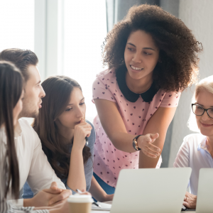 Image of a group of adults around a laptop