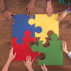 Image of hands putting together large puzzle pieces
