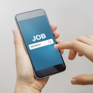 Image of a phone in a hand with a job search on the phone. 