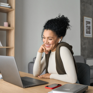 woman looking at laptop smiling